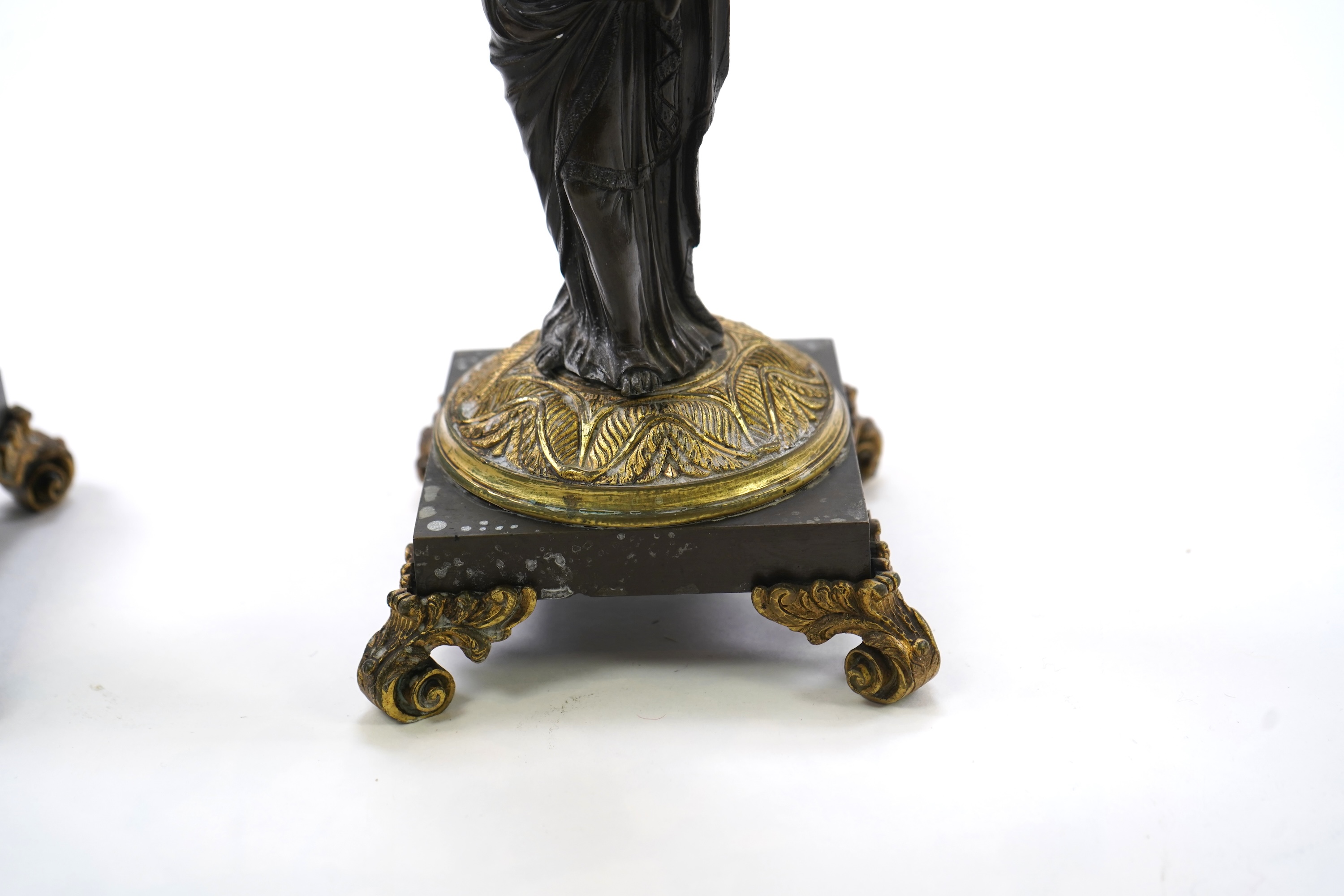 After Mathurin Moreau. A pair of mid 19th century bronze and gilt bronze two branch candelabra